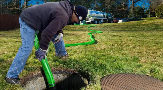 Service technician performing residential septic pumping and drainage maintenance in Stamford, CT